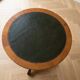 Empire style gueridon in solid wood and green leather.