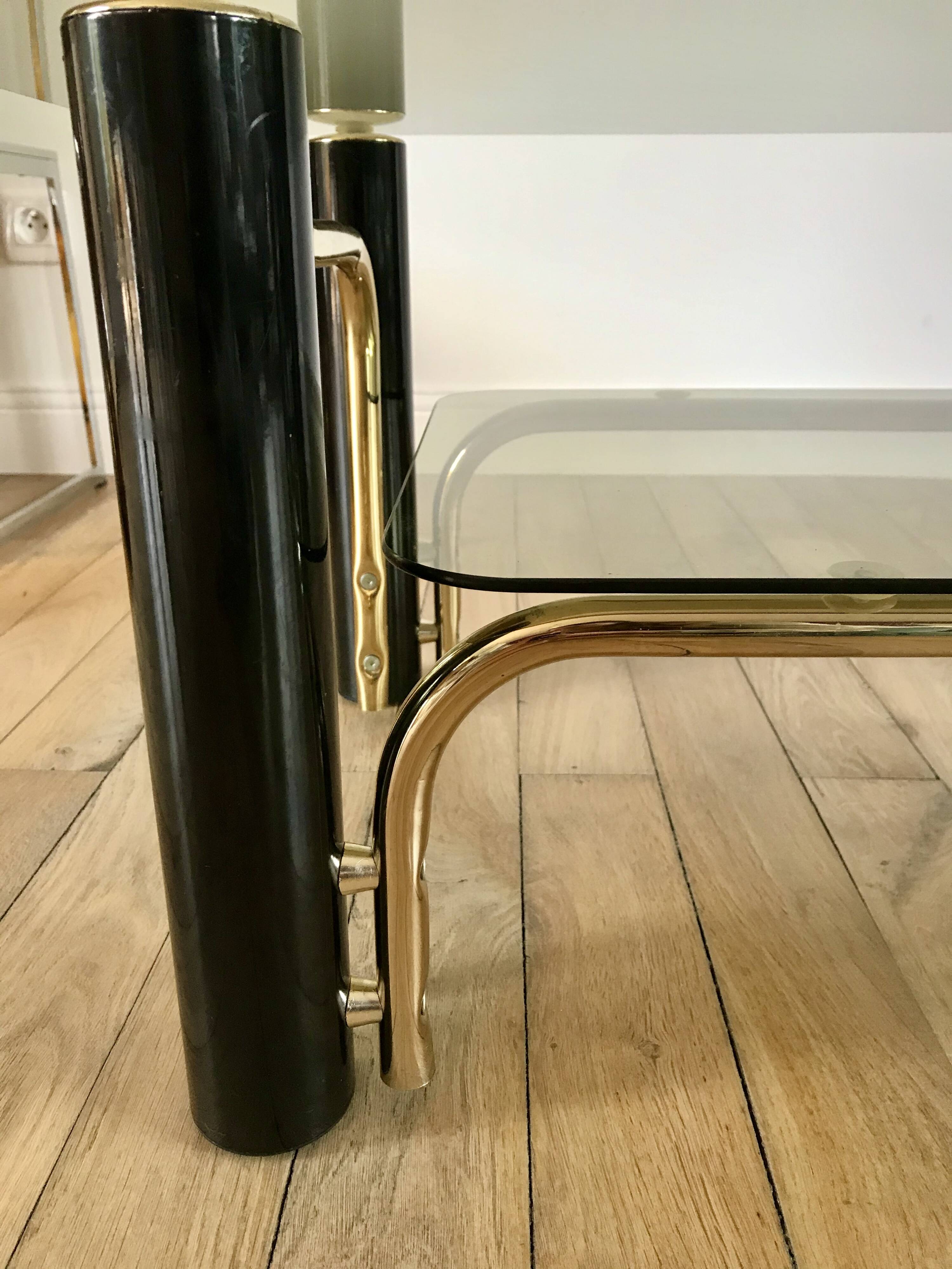 coffee table in smoked glass and black and gold metal from the 70s