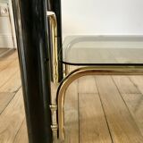 coffee table in smoked glass and black and gold metal from the 70s