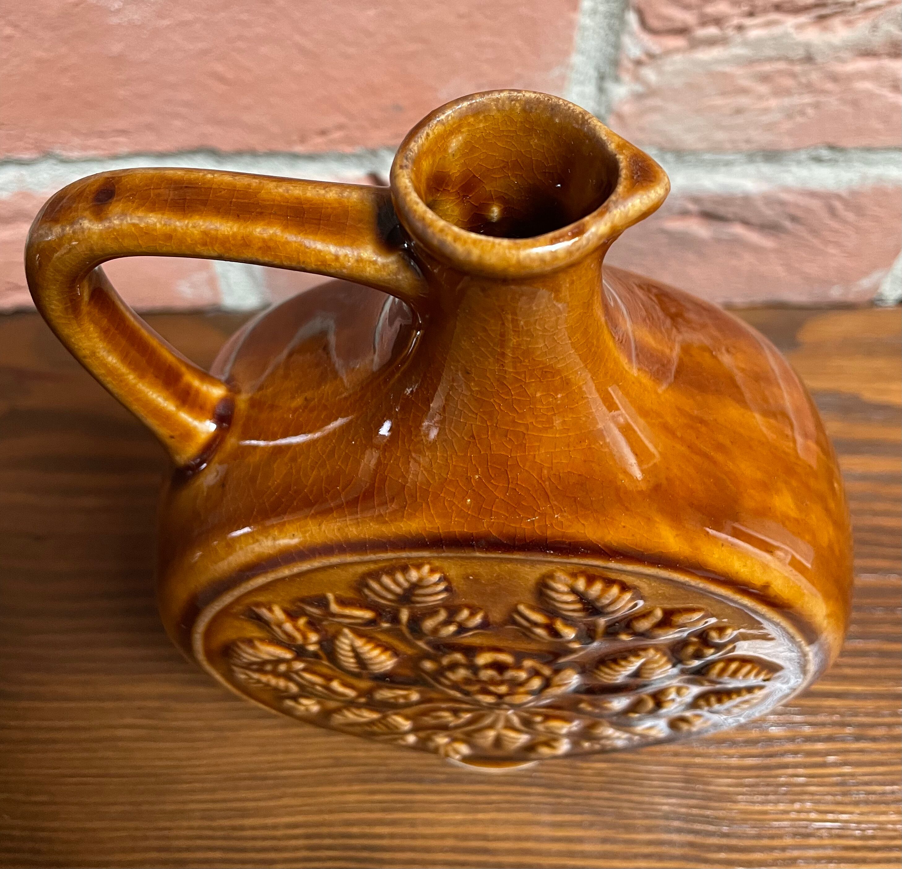 German round vase with floral motif, ornamental brown ceramic jug with handle