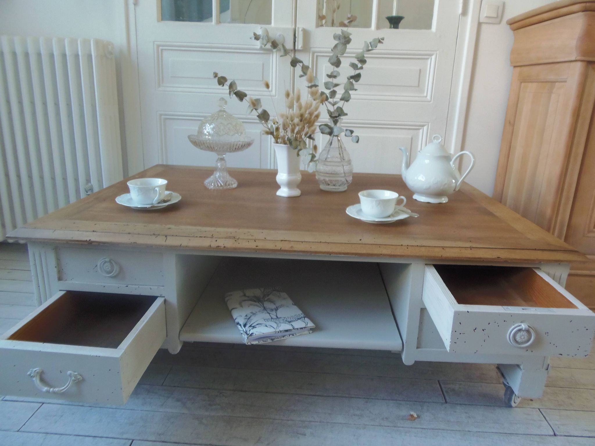 Coffee table on casters, made from an old desk, pearl gray base and belt.