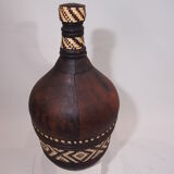 Old bottle in leather