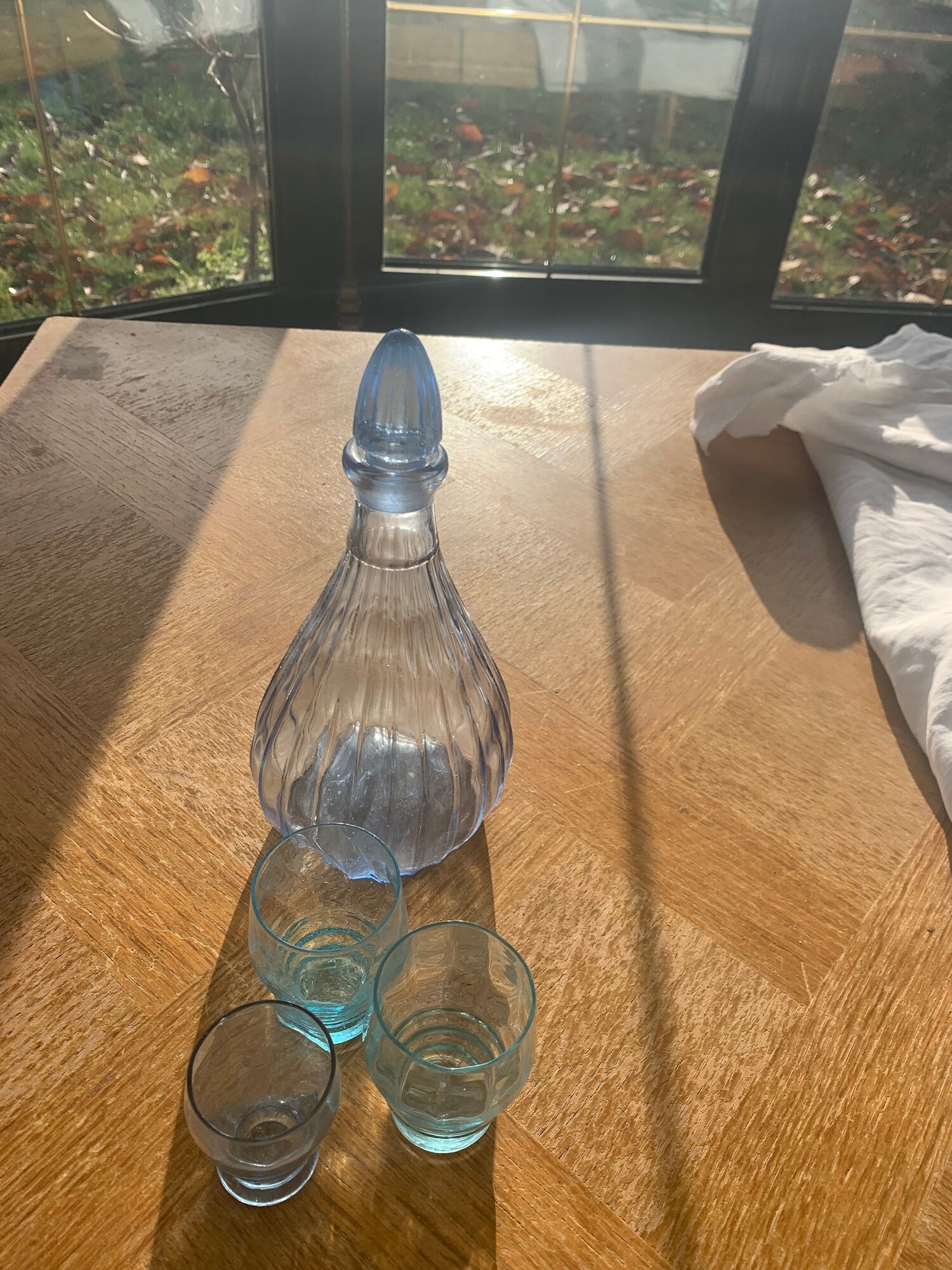 Liquor service consisting of a blue glass decanter and. 3 small antique glasses