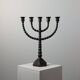 Candelabrum in the shape of a spool, skilfully forged in menorah style.