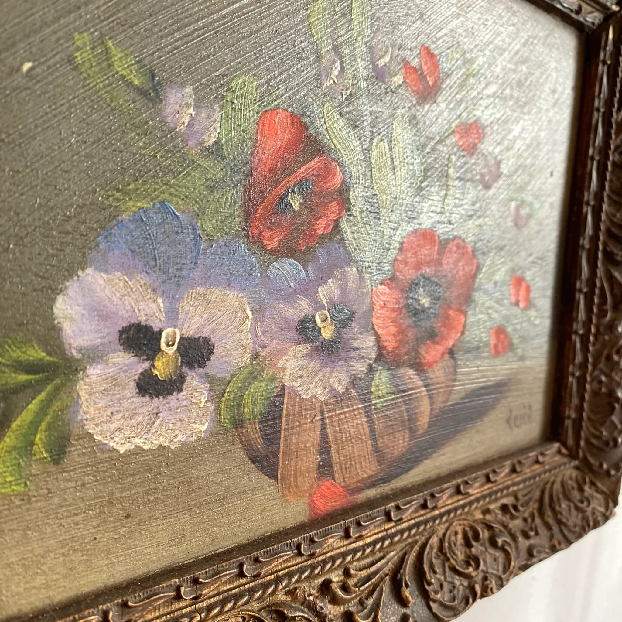 Old painting of a bouquet of pansies and poppies.