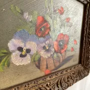 Old painting of a bouquet of pansies and poppies.