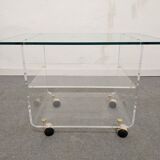 End of sofa with glass and plexiglass wheels from the 70s