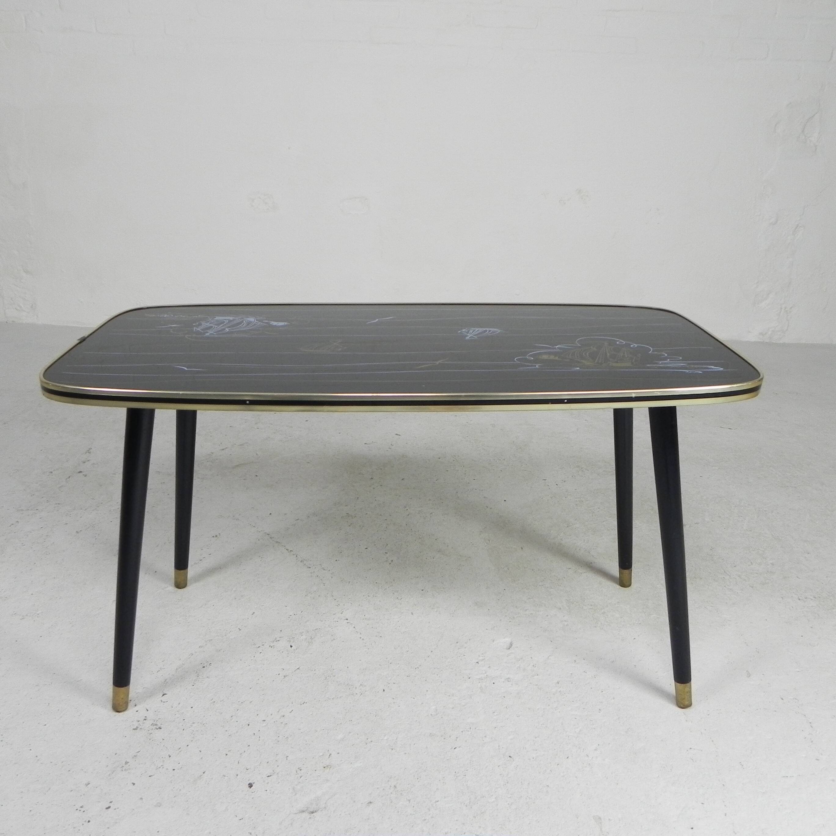 Vintage coffee table with glass top and angled legs