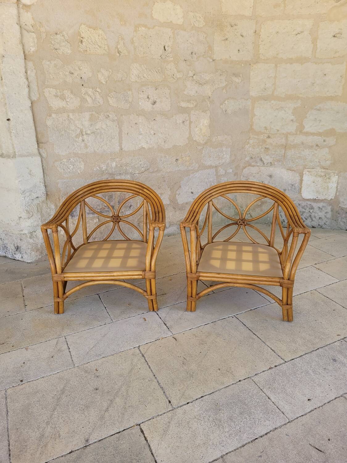Two large rattan armchairs