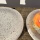 4 black speckled dessert plates on a vintage white background