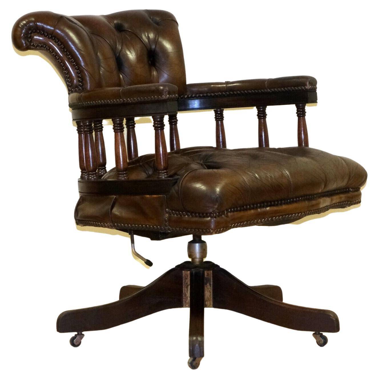 Restored Chesterfield captain's armchair in leather with an oak frame.