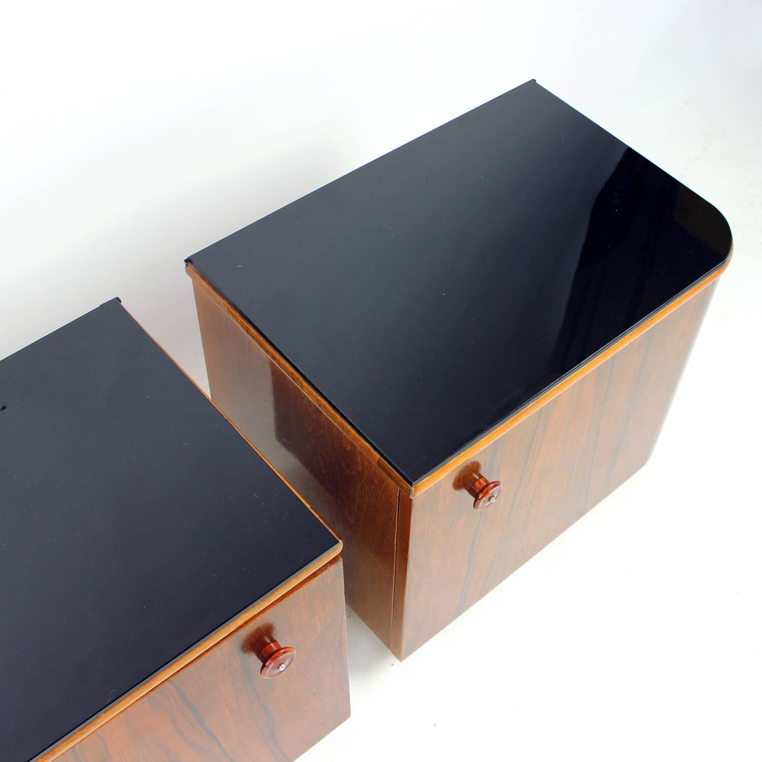 Pair of Art Deco bedside tables in walnut and black glass, Czechoslovakia.