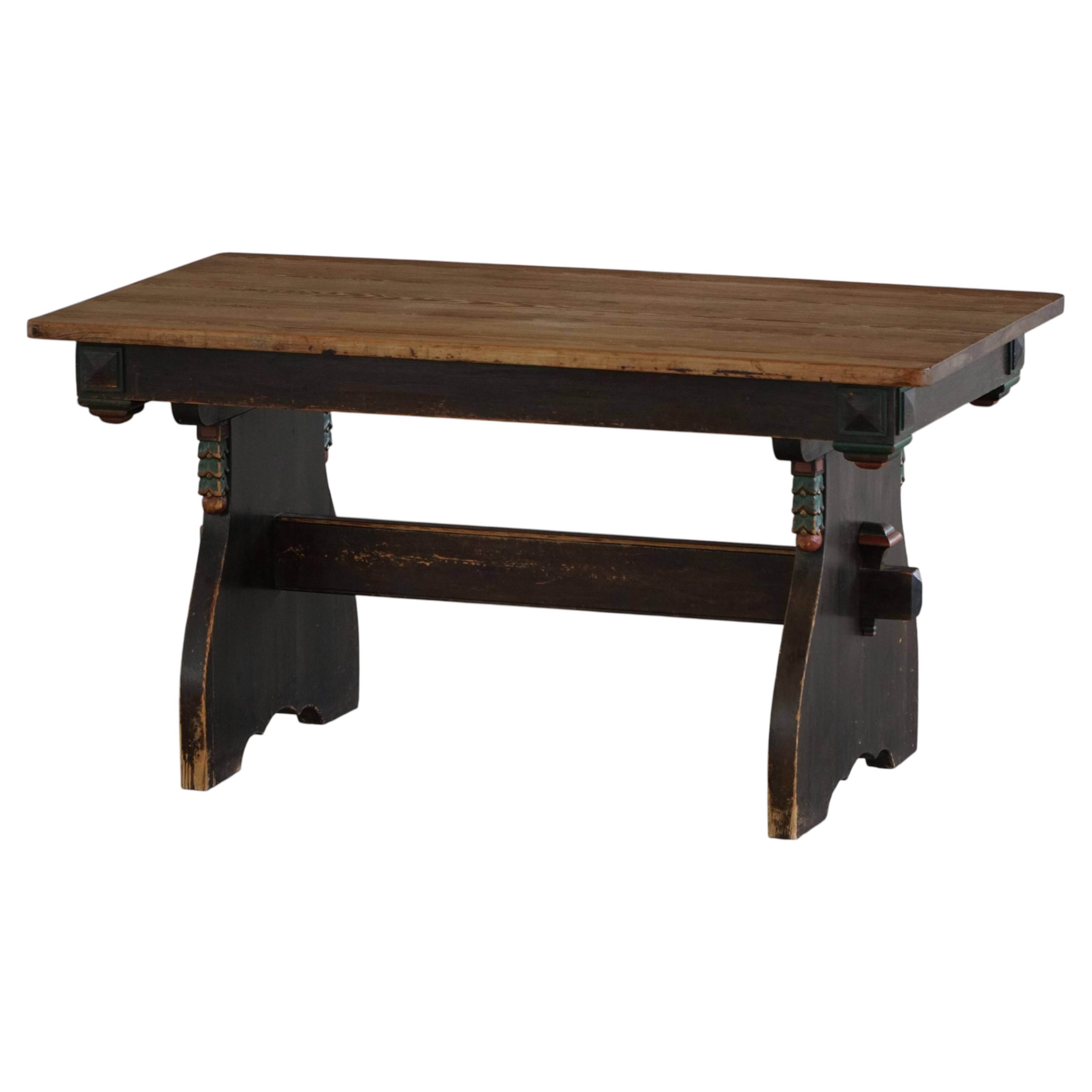 Rustic Scandinavian dining table in stained pine, Sweden, 1900-1940.