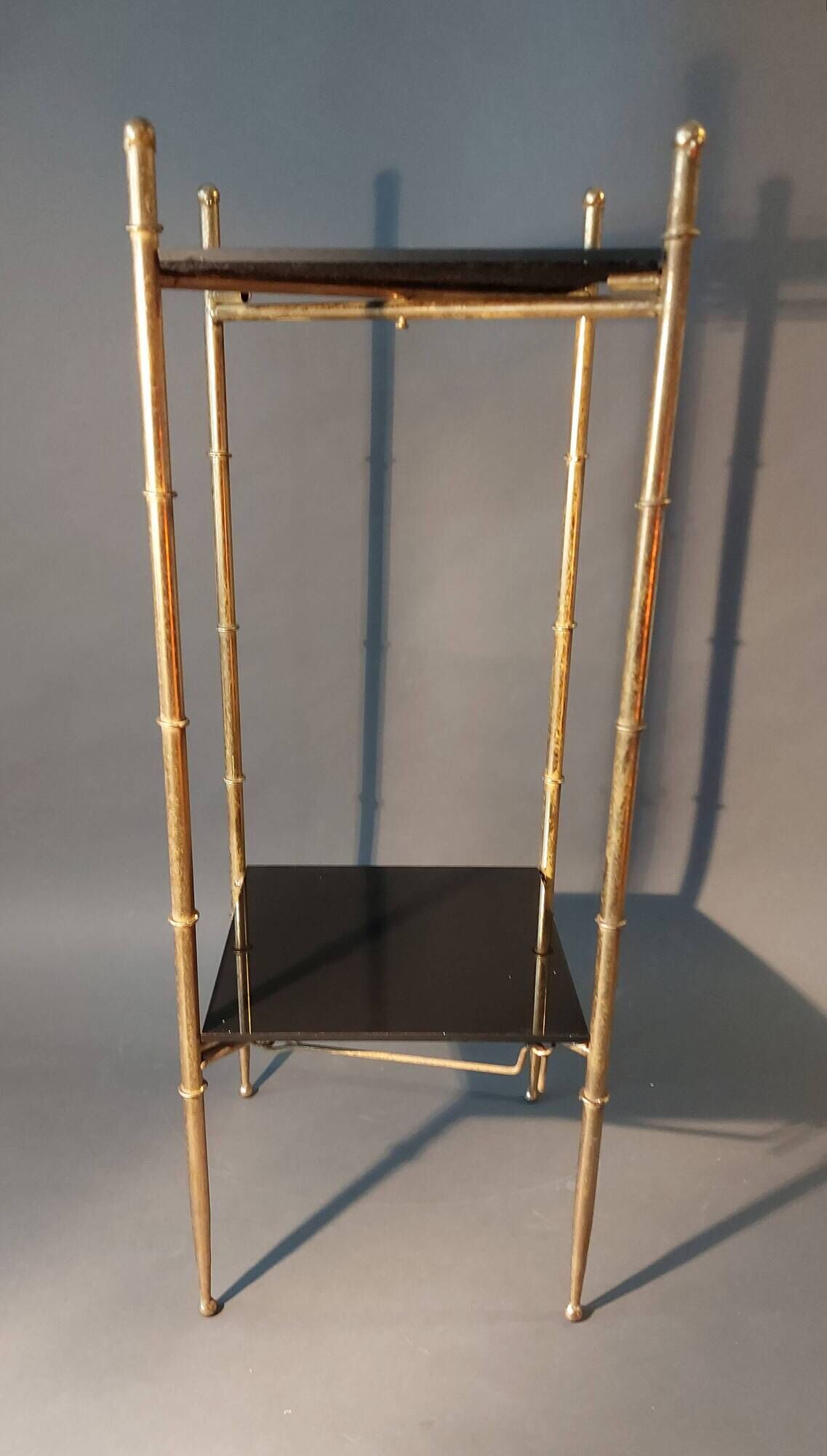 Pedestal table in patinated gilded brass faux foldable bamboo.