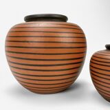 Pair of Elchinger ball vases with asymmetrical black stripes on an auburn background