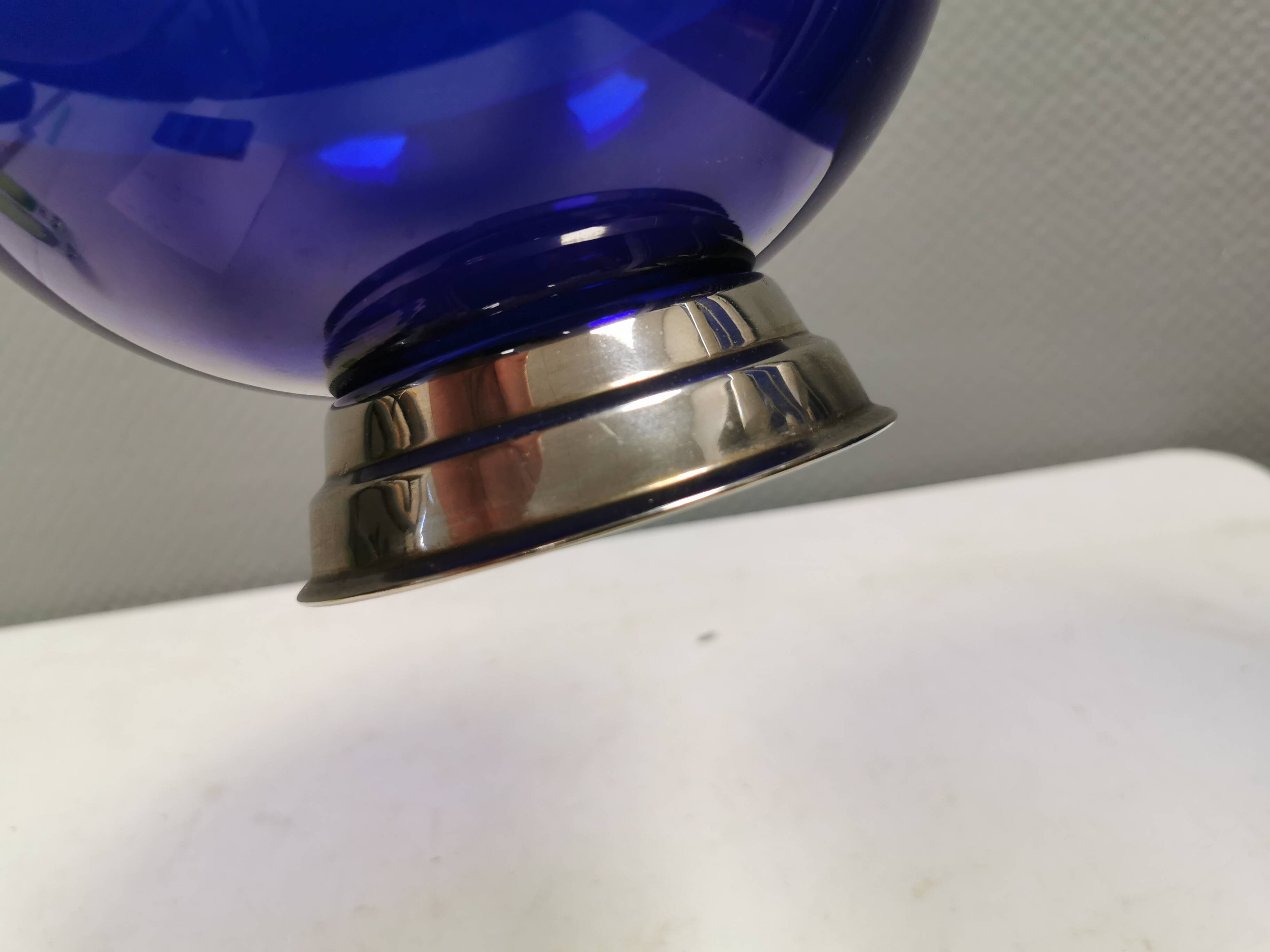 Beautiful blue glass bowl mounted on silver colored base (Original).