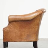 Very comfortable, elegant leather club armchair with a removable seat cushion and timeless design