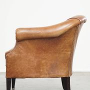 Very comfortable, elegant leather club armchair with a removable seat cushion and timeless design