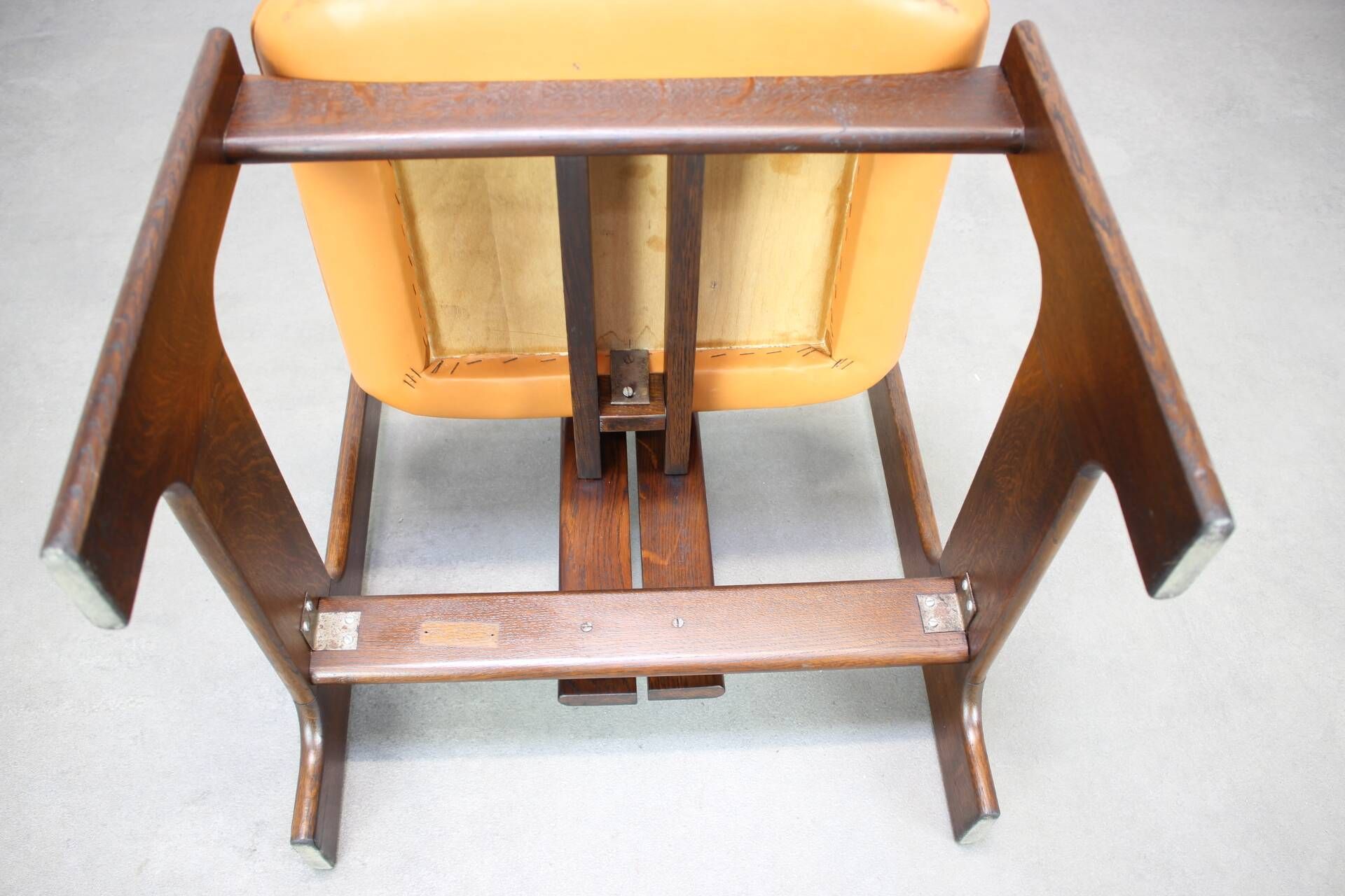 Vintage German sculptural chair from the 1970s in wood with orange faux leather.
