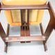 Vintage German sculptural chair from the 1970s in wood with orange faux leather.