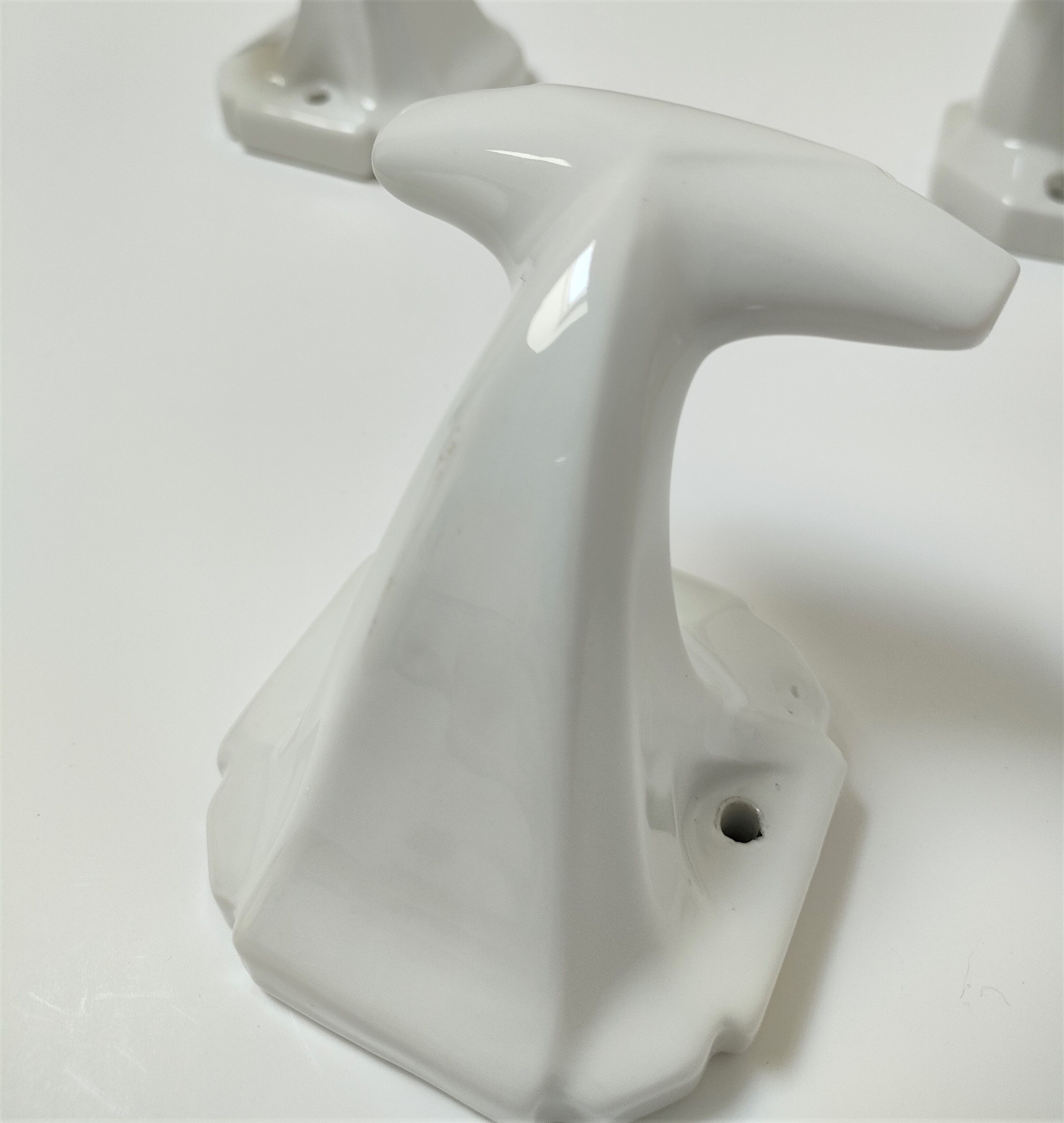 Five art deco white porcelain hooks