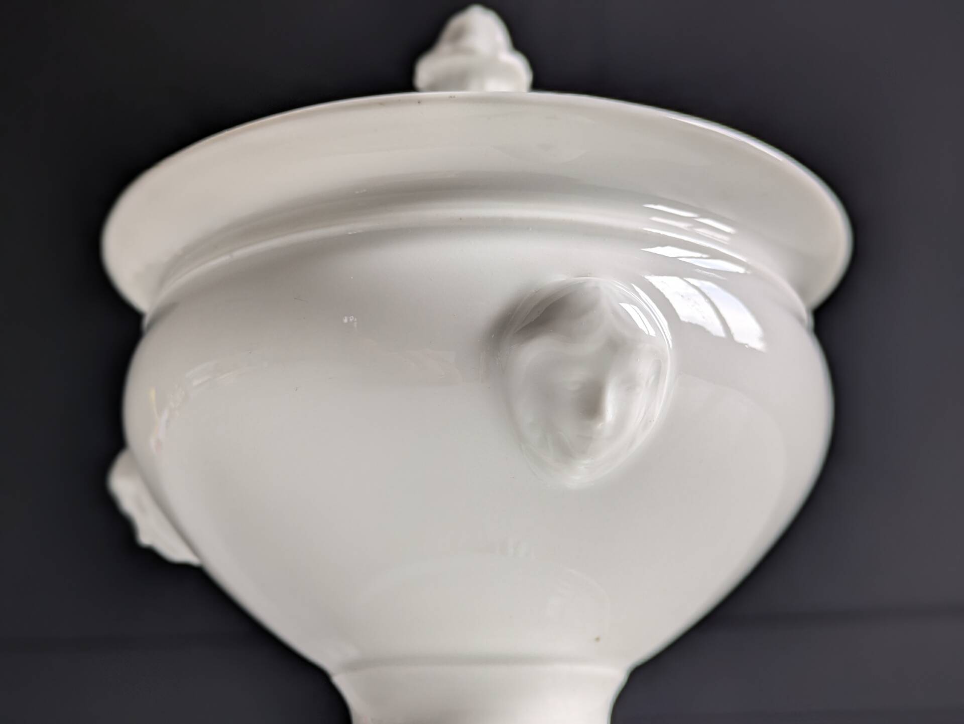 White porcelain confiturier with lion paws and masks. 19th century.