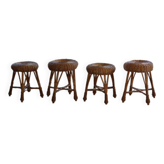 A set of 4 vintage Scandinavian rattan stools, in the style of Tony Paul, from the 1960s.