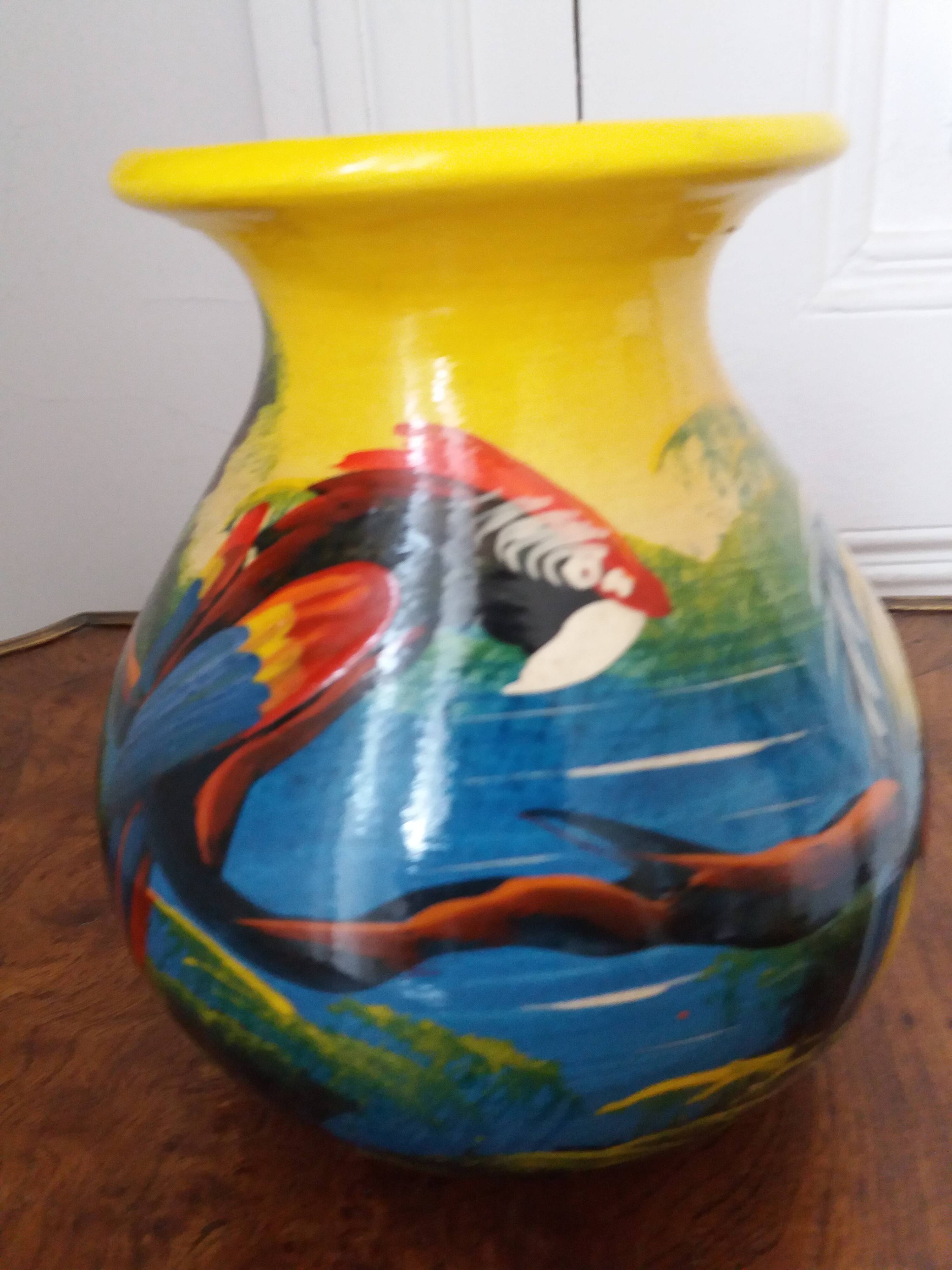 Mexican popular art vase decorated with parrots and toucans.