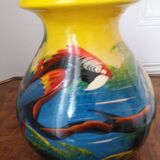 Mexican popular art vase decorated with parrots and toucans.