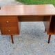 60s desk in golden blond mahogany with conical coffered feet