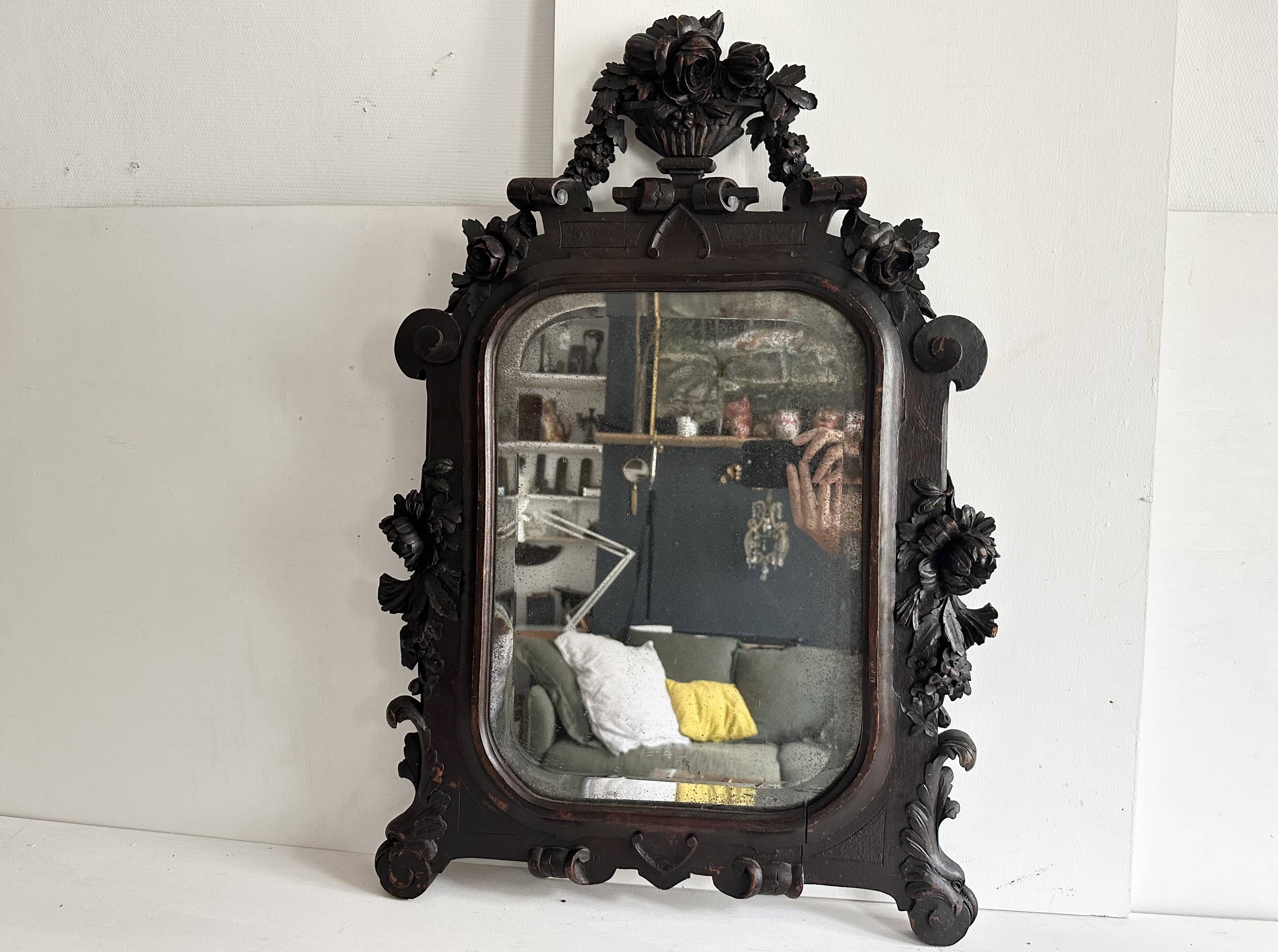 Napoleon III mirror in carved blackened wood, 19th century