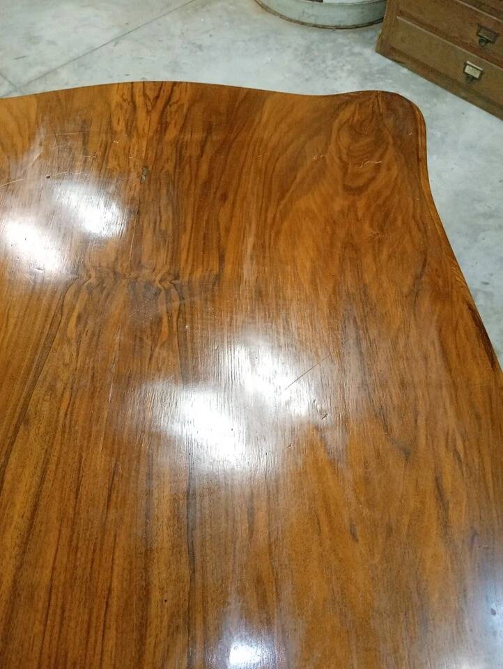 Curved desk in Louis XV style, made of carved and moulded walnut.
