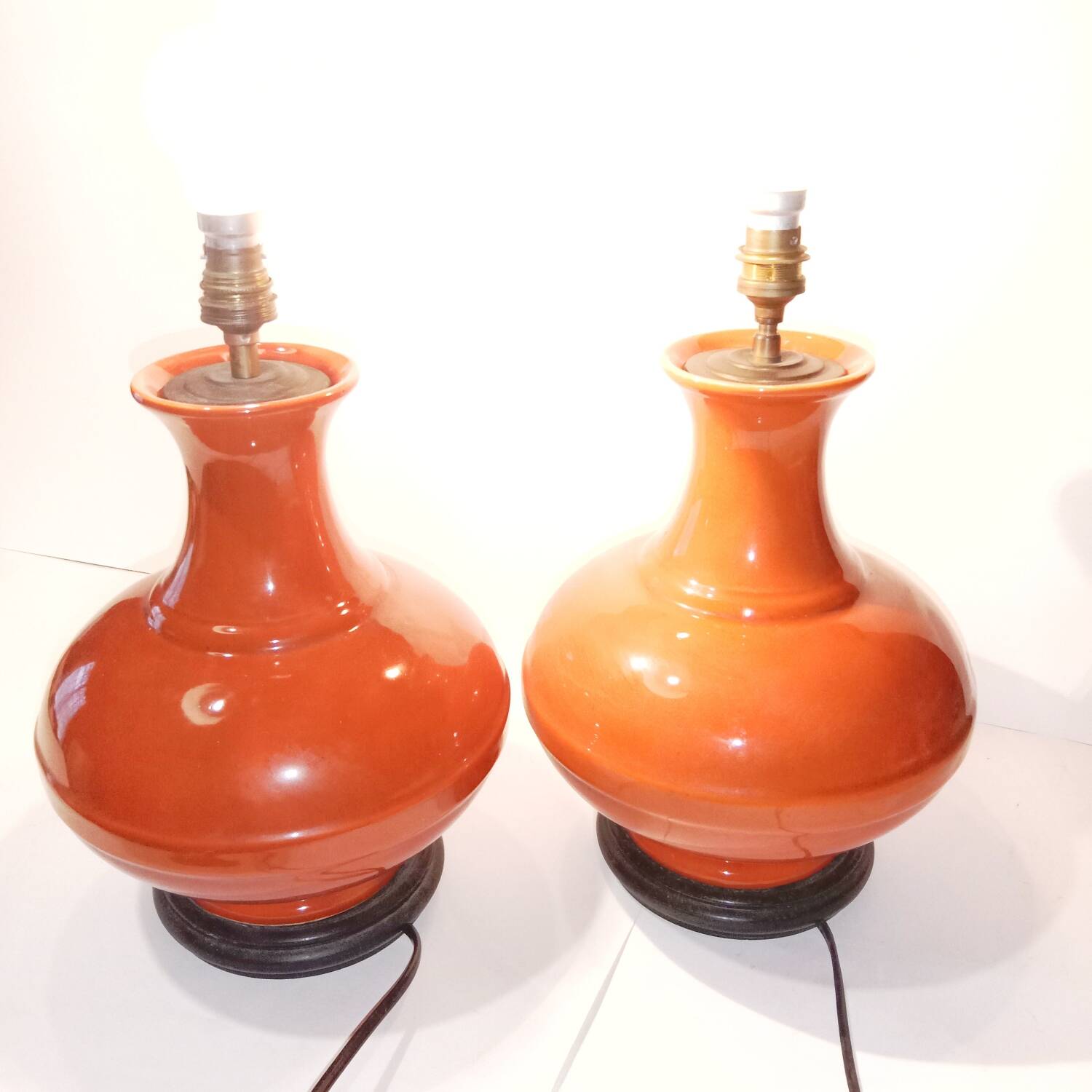 Pair of ceramic lamp bases in the shape of orange gourds.