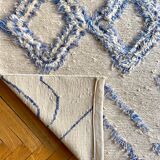 Berber cream carpet with blue patterns