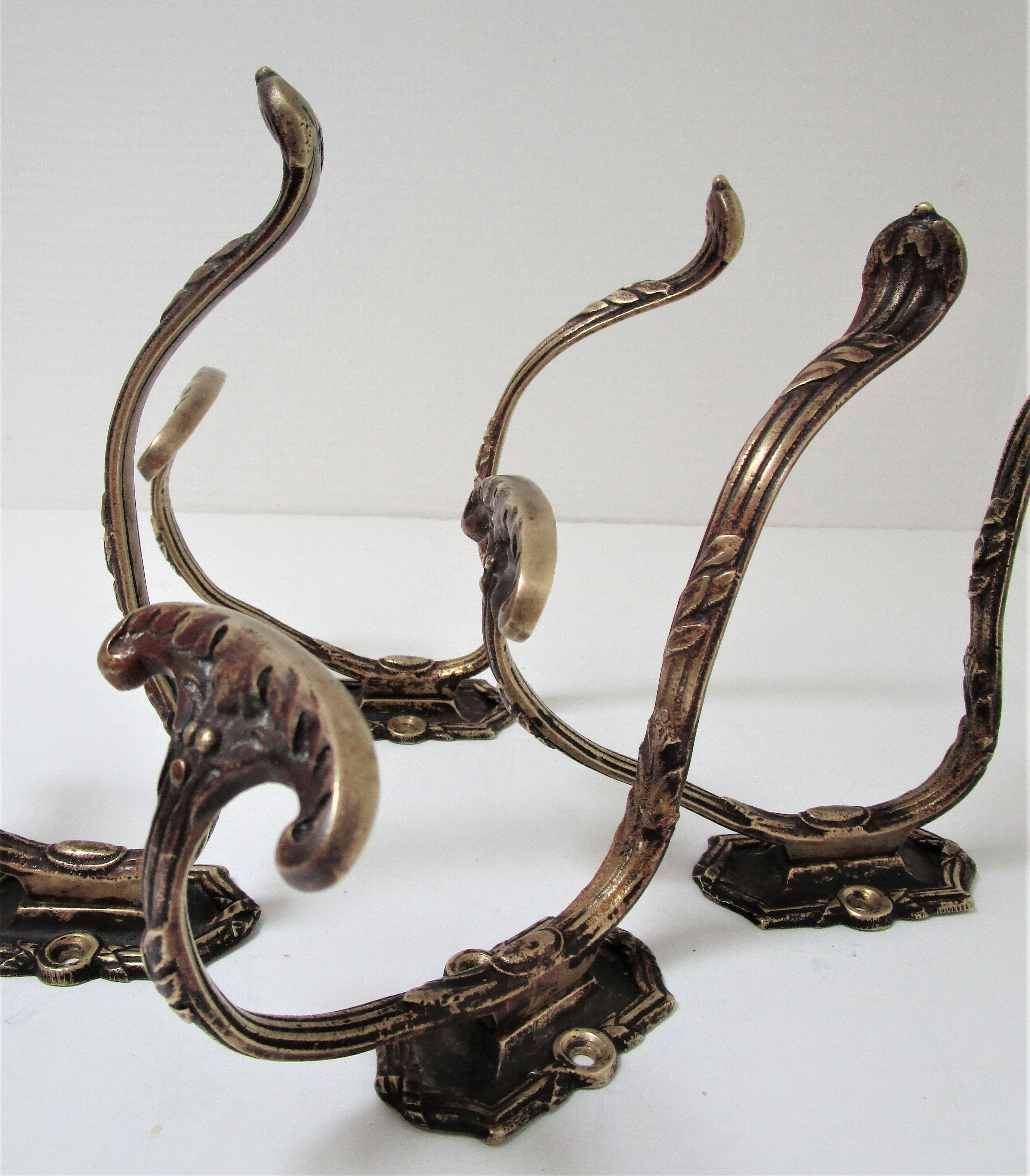Four patères bronze patinated leafy décor early 20th century