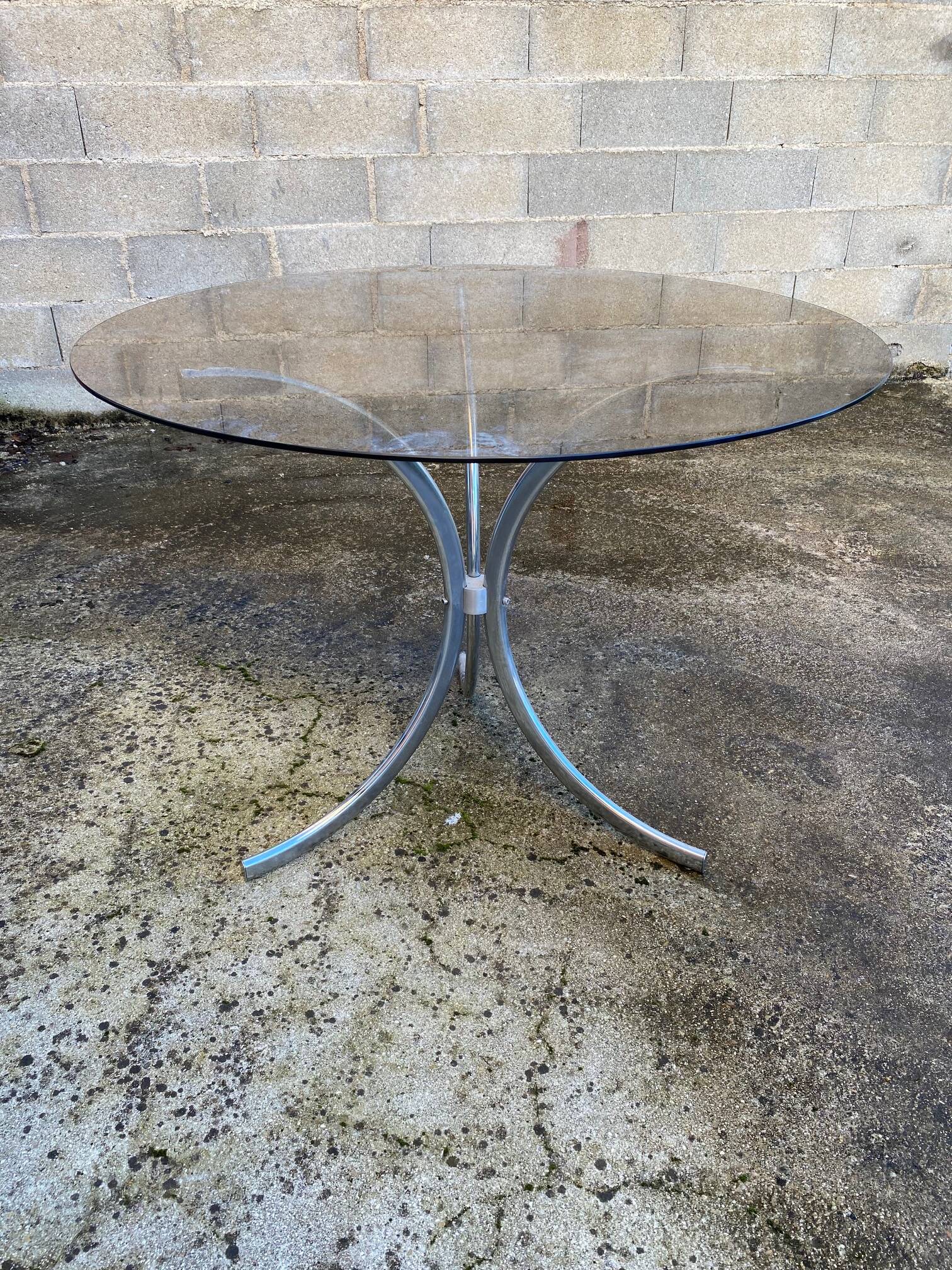 Table with chrome metal legs and smoked glass top.