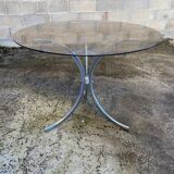 Table with chrome metal legs and smoked glass top.