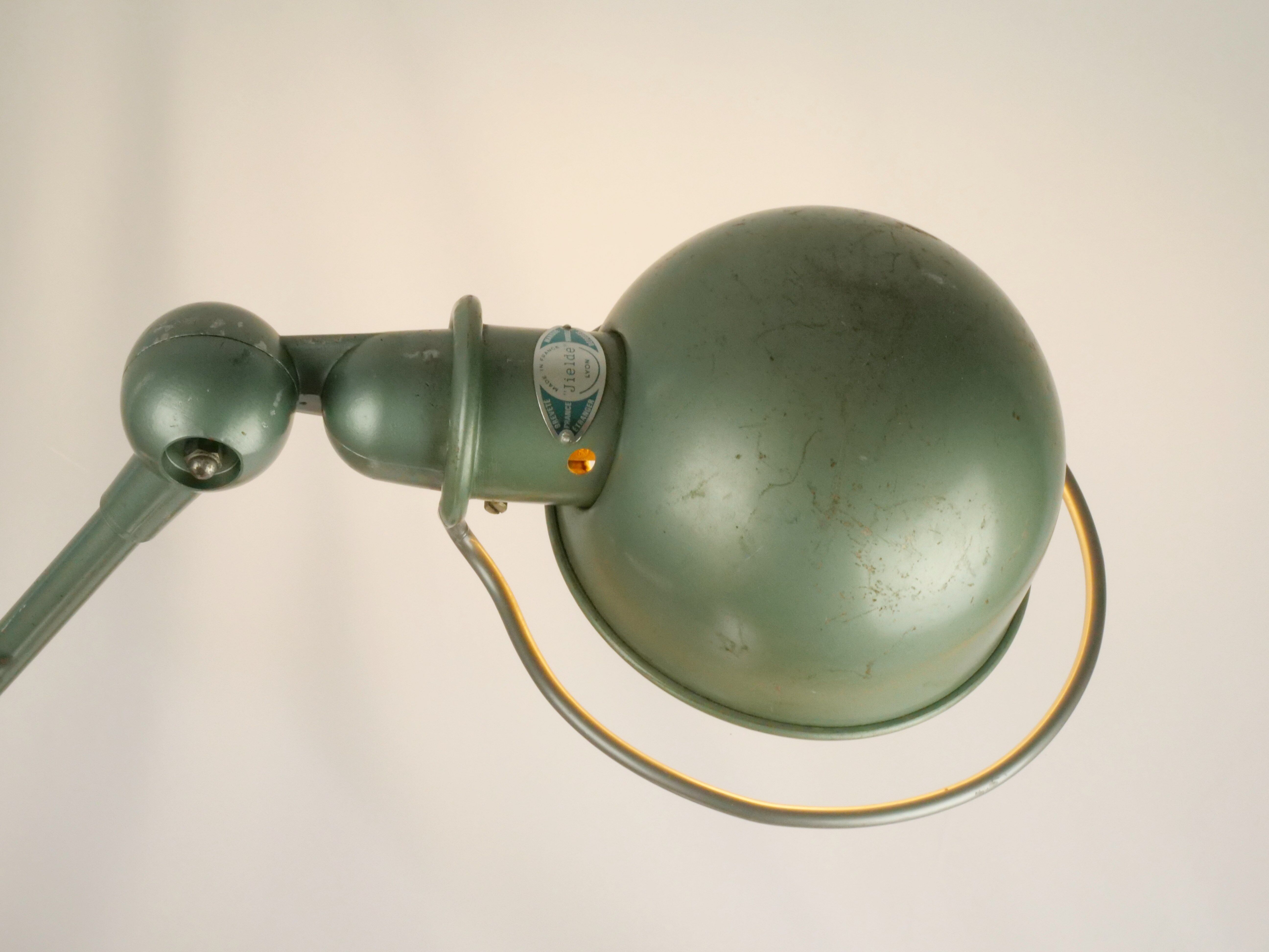 Jielde table lamp with 2 arms on a wooden base.