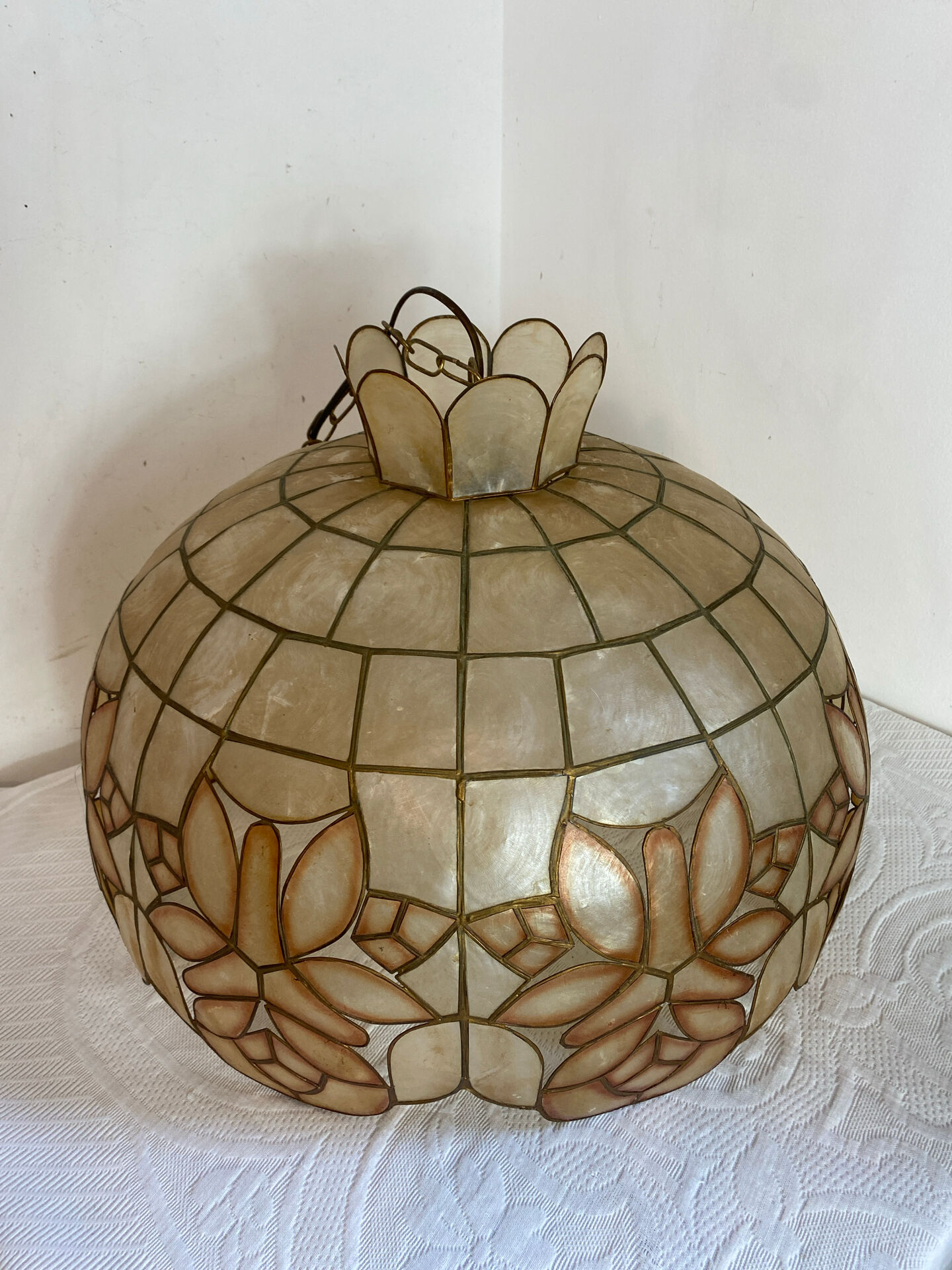 Large mother-of-pearl and brass chandelier with floral decoration.