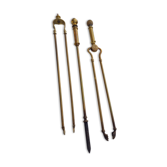 Mismatched set of chimney accessories two pliers and a fire pier