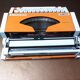 Olympia traveller luxury typewriter orange revised and new ribbon