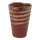 Small orange glazed ceramic cup