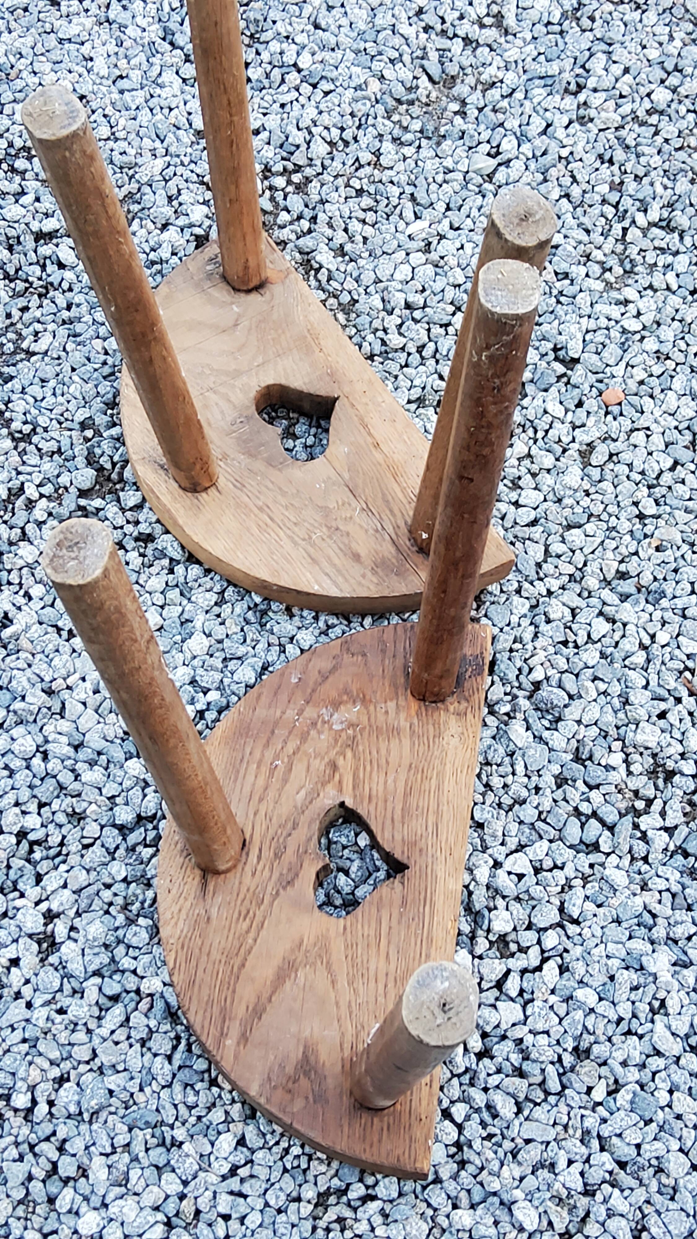 Pair of shepherd's stools in tripod oak décor in the heart
