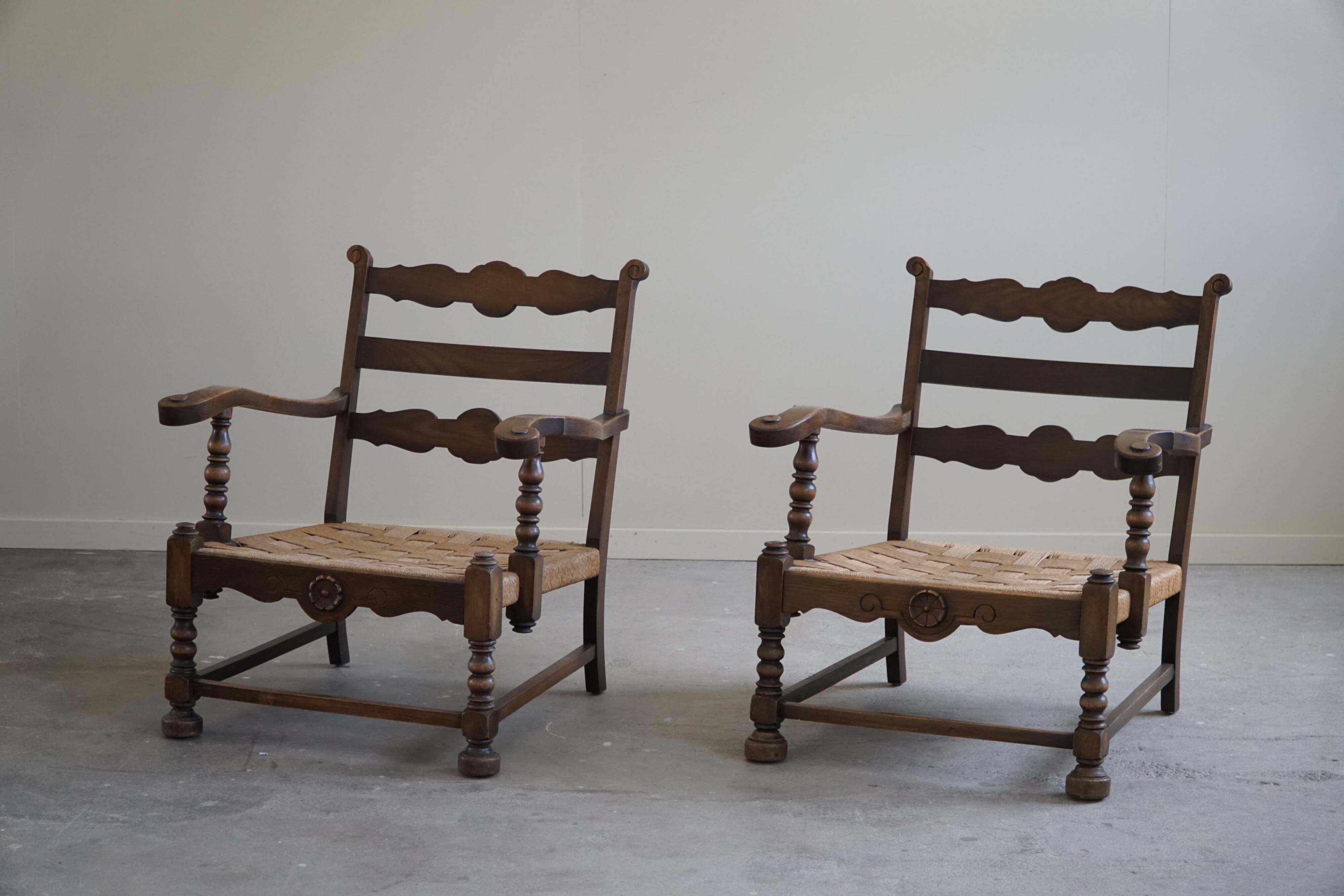 A pair of modern and sculptural vintage Danish armchairs in oak and papercord, 1940s.