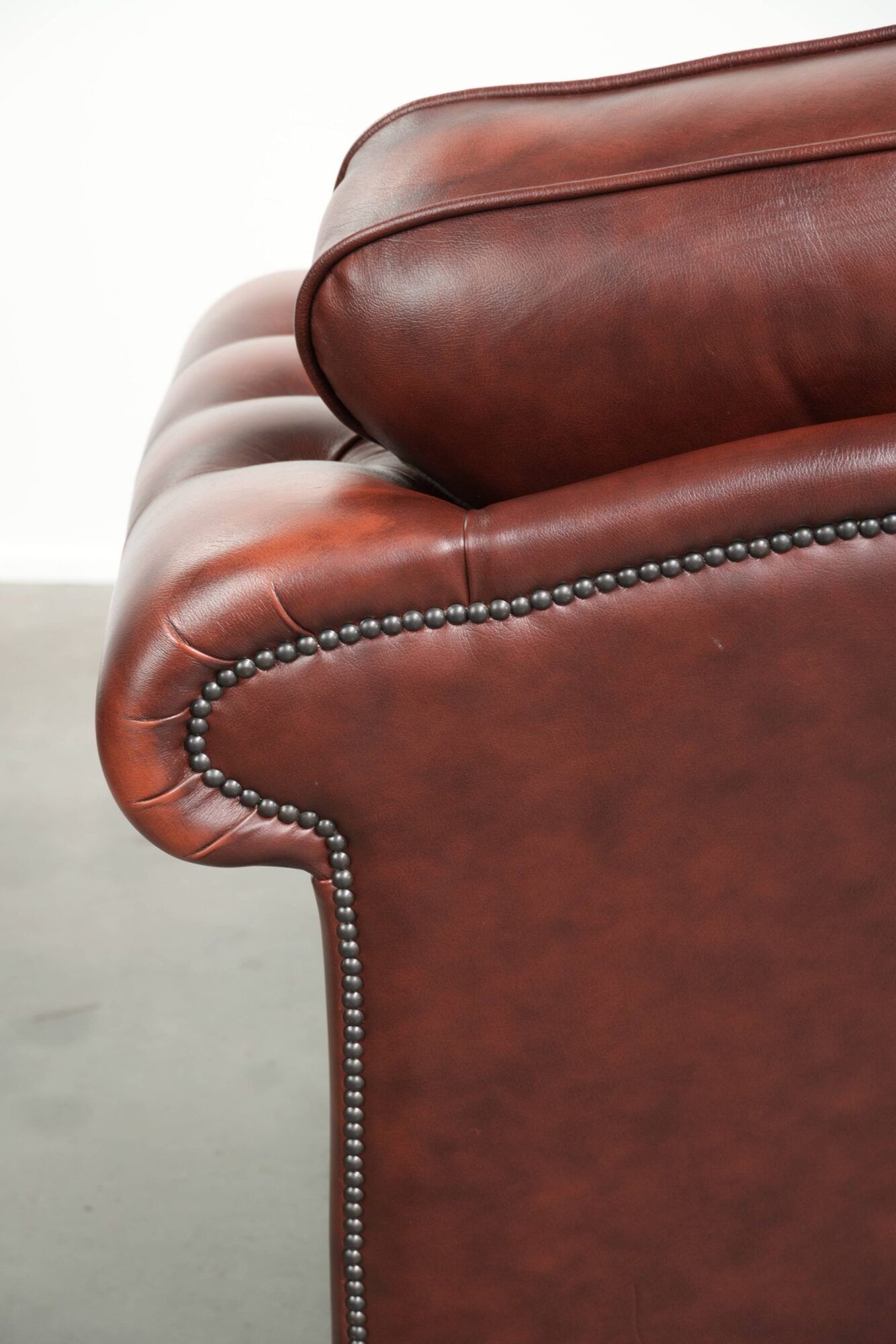 Vintage set of 2 cowhide leather Chesterfield armchairs in a brown colour