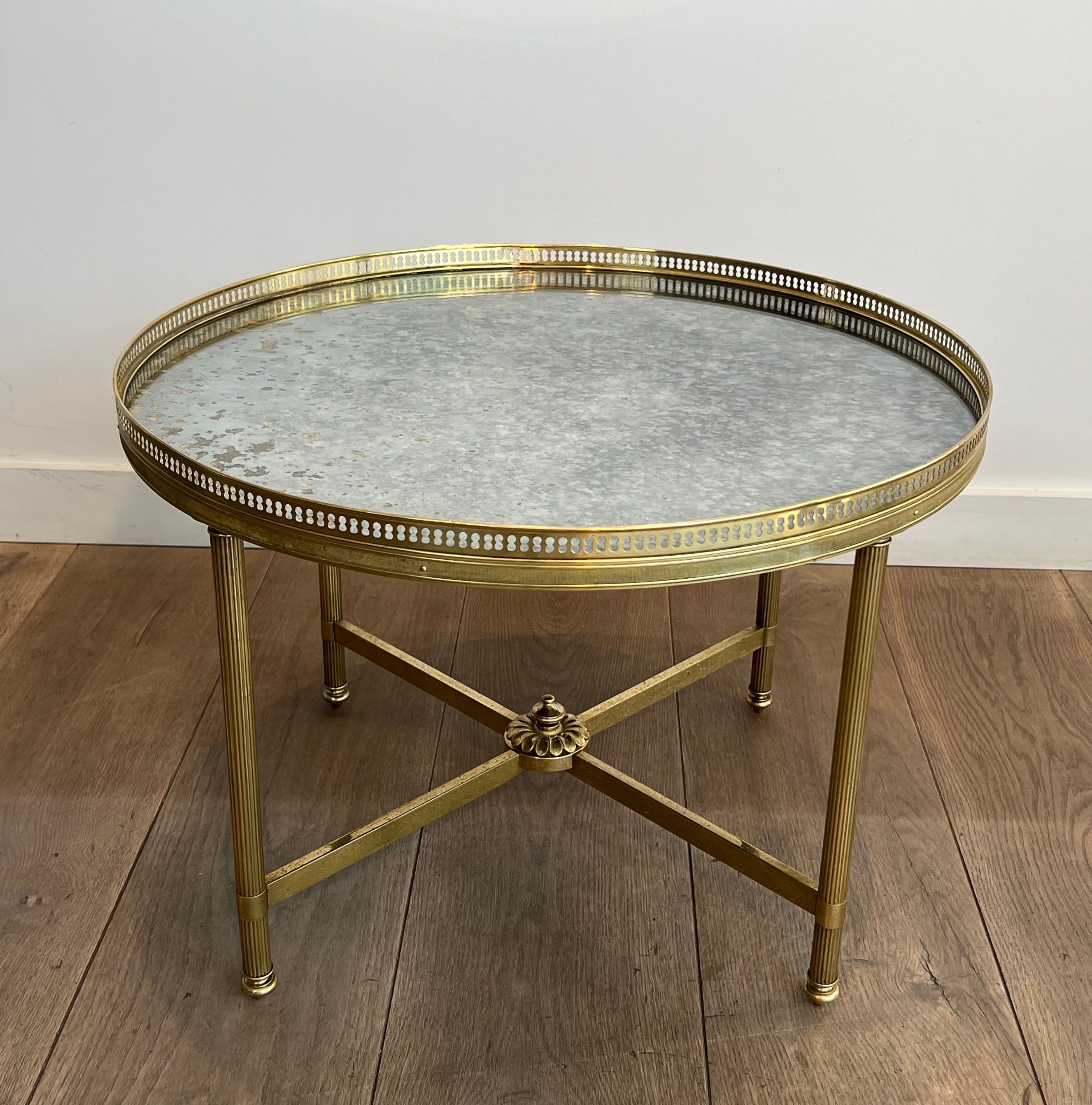 Brass coffee table with a vintage mirror top from the Baguès house.