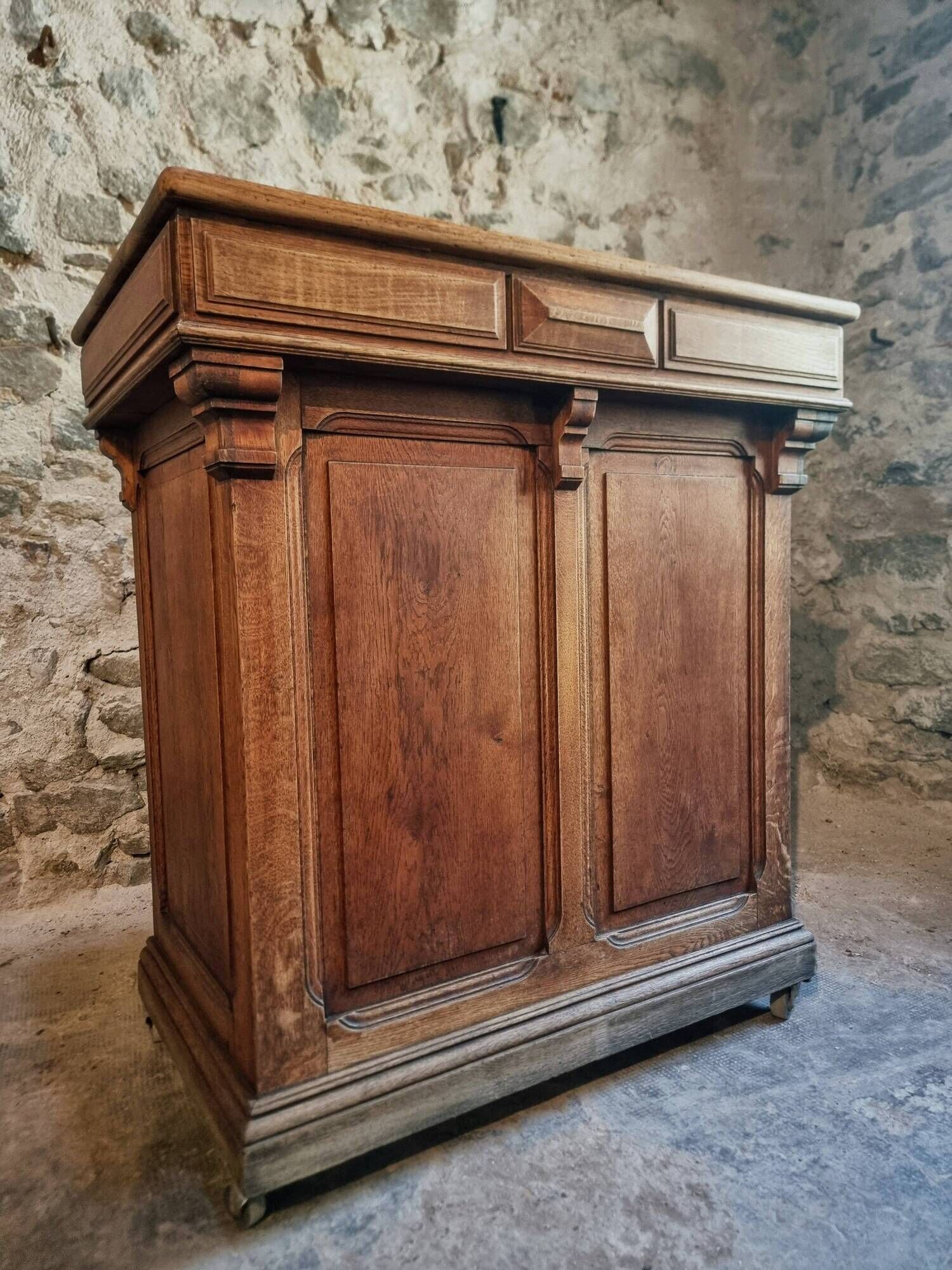 Antique French oak shop counter, kitchen island on wheels, circa 1880–1900.
