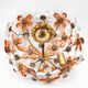 Ceiling light with transparent and peach flowers.