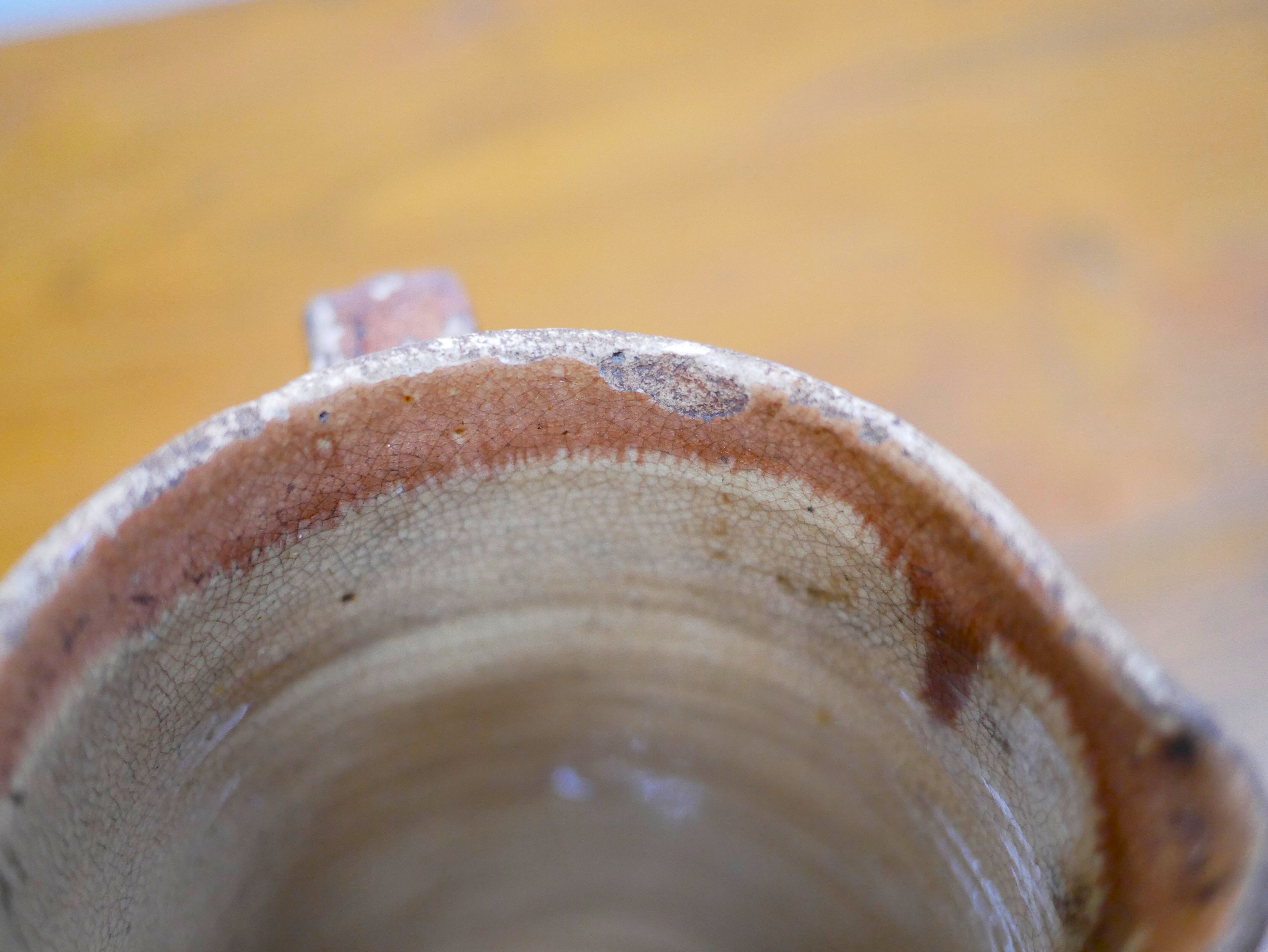 Vintage pitcher in glazed terracotta