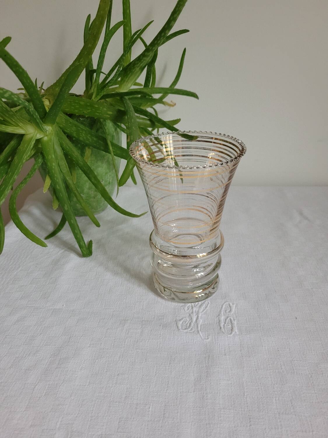 Flared glass vase with gold trim
